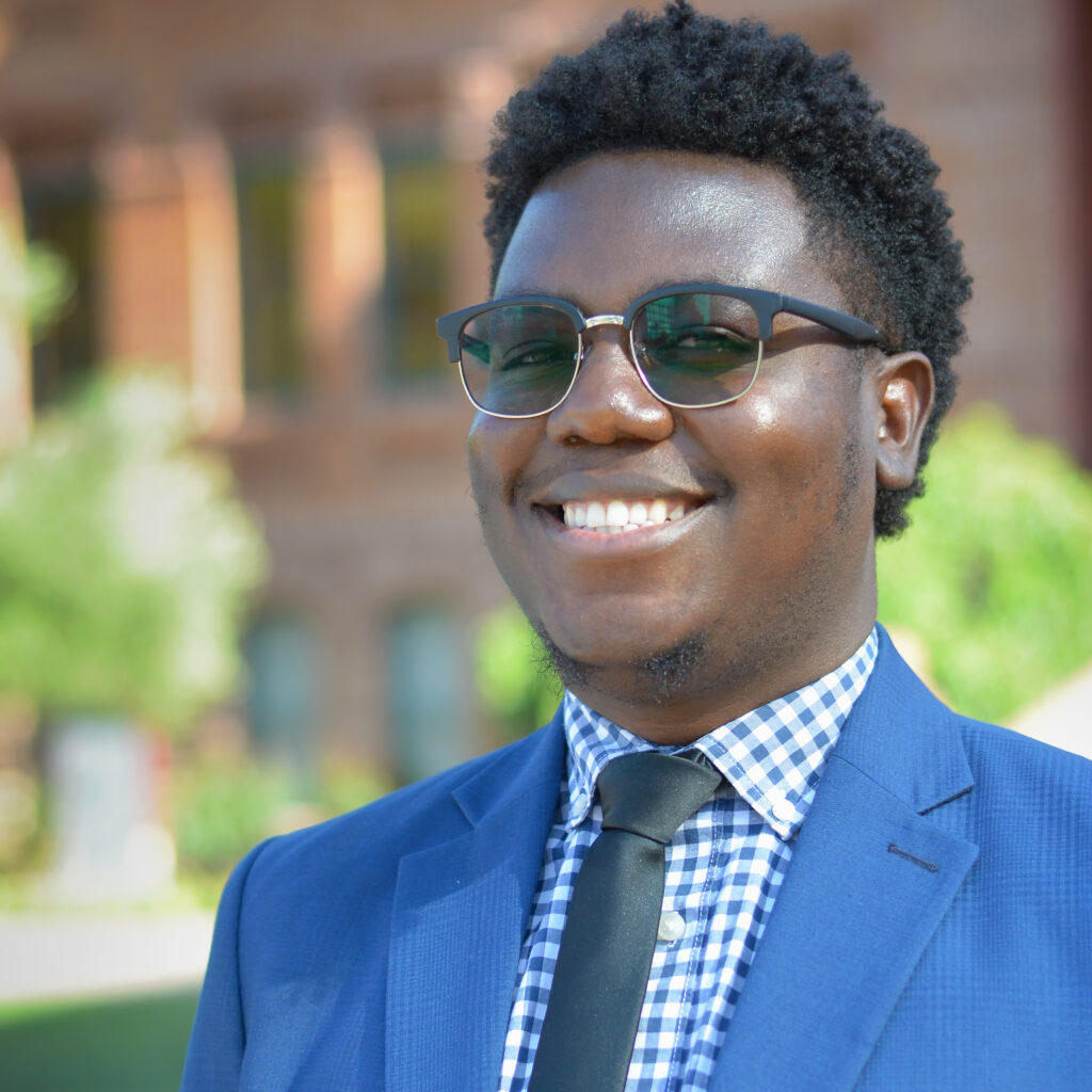 Paye Kialain smiling for a headshot in front of Old Main on ASU's Tempe campus.