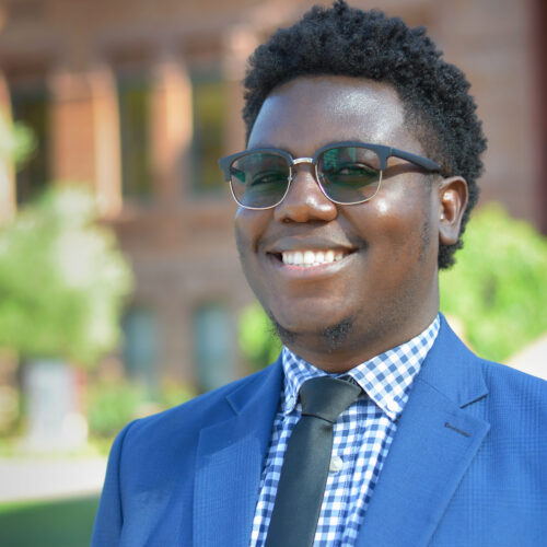 Paye Kialain smiling for a headshot in front of Old Main on ASU's Tempe campus.