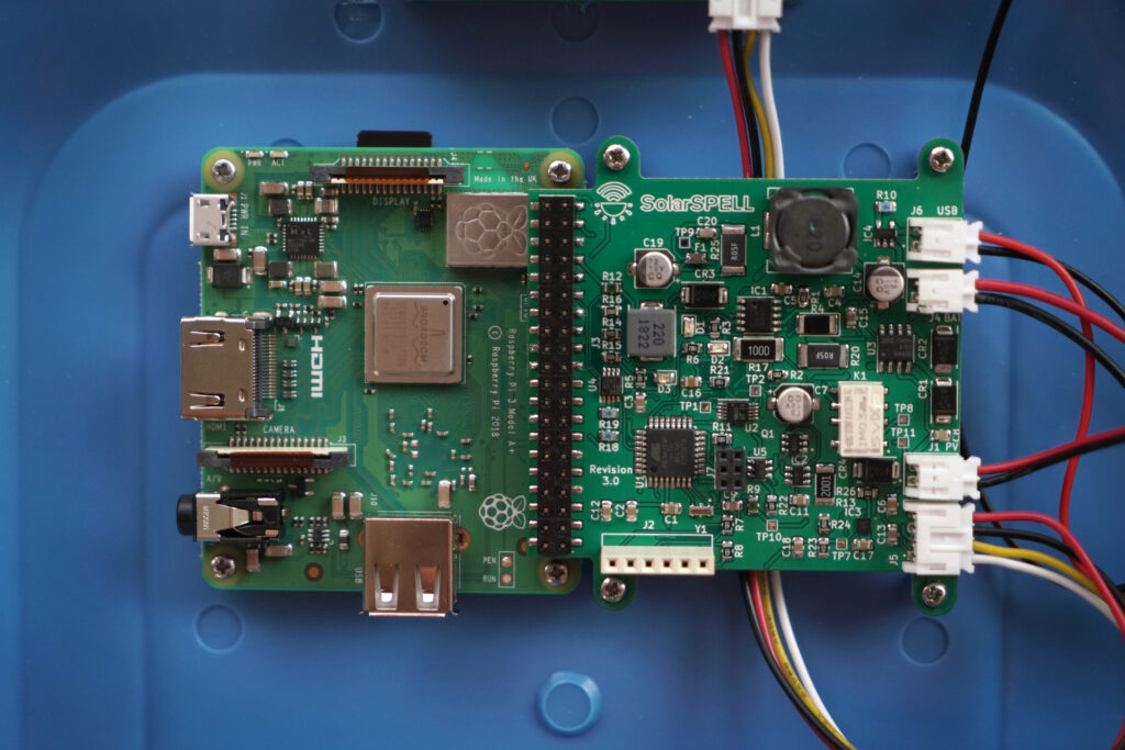 The SolarSPELL printed circuit board (PCB) charge controller connected to a Raspberry Pi 3 PCB microcomputer.